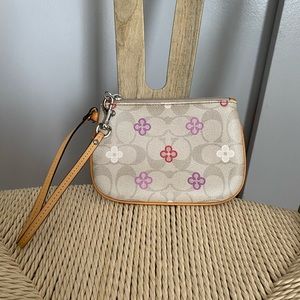 Classic coach Wristlet w/ flower prints & in good condition.